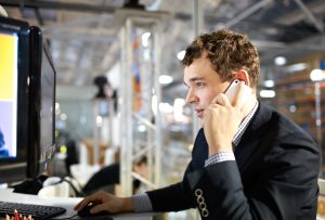 Working and talking on the phone.