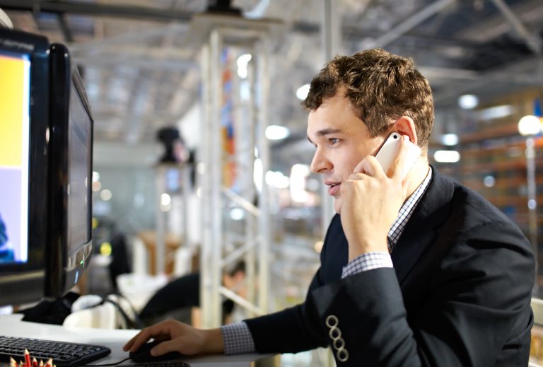 Working and talking on the phone.